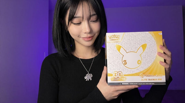 Pokemon 30th Celebration Pokemon Center Elite Trainer Box held by the Evol Vault content host, showing the Pikachu 30th anniversary front artwork