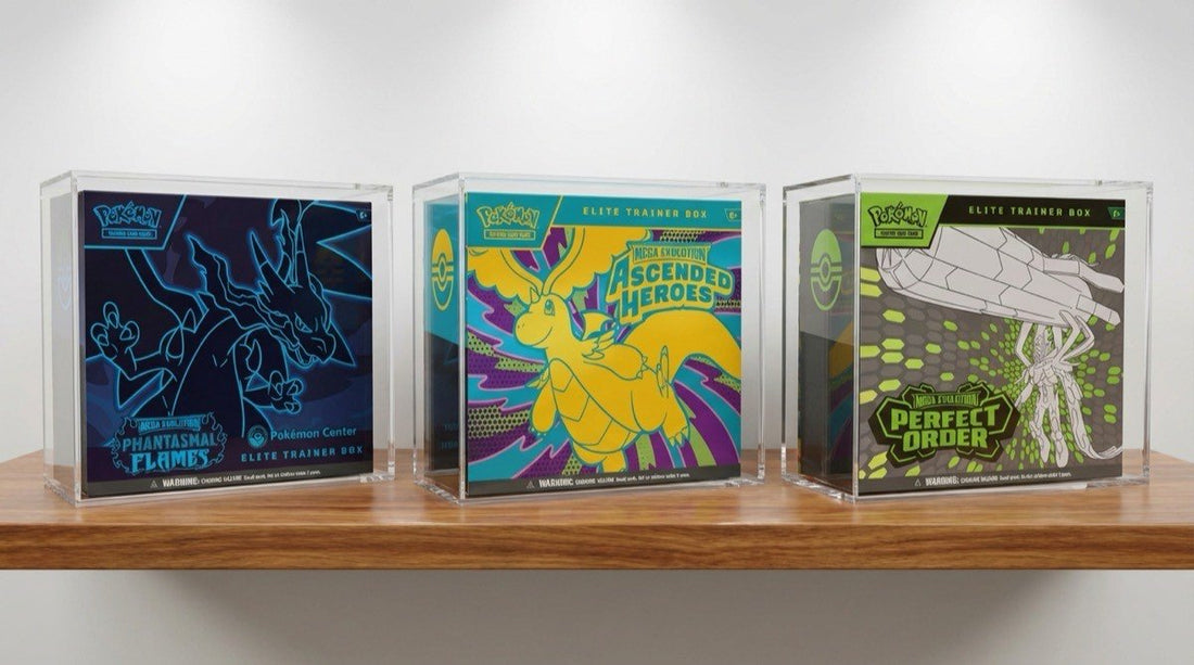 Three Pokemon Center ETBs stored in clear acrylic display cases on wooden shelf