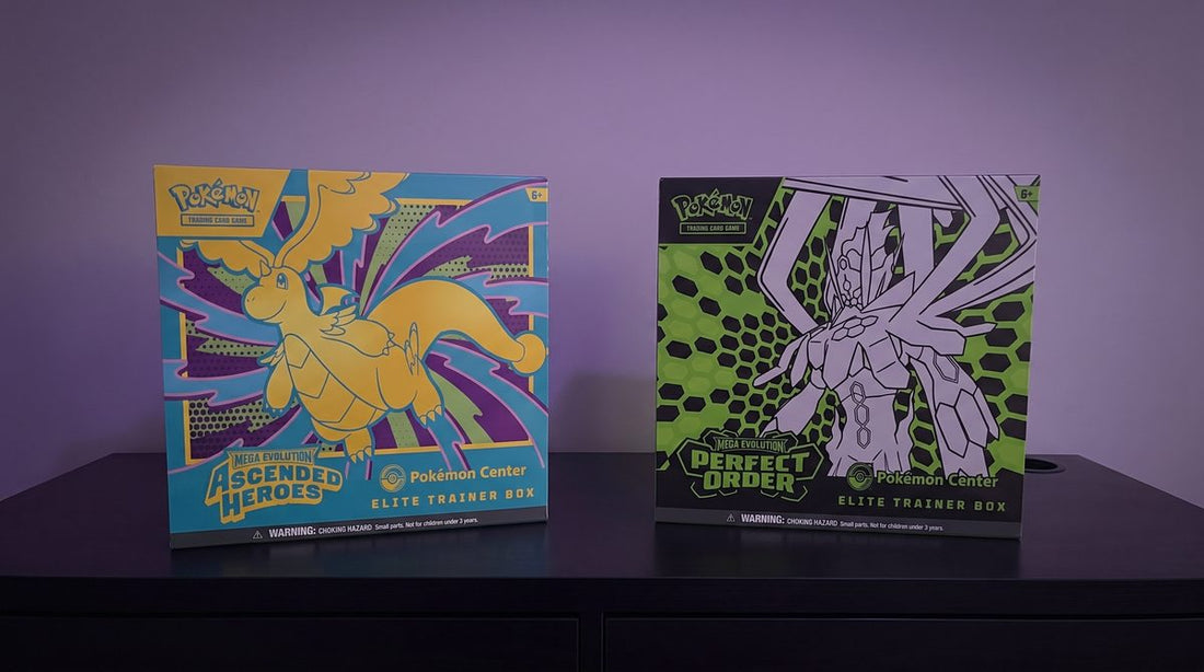 The Ascended Heroes and Perfect Order Pokemon Center Elite Trainer Boxes side by side on a black desk