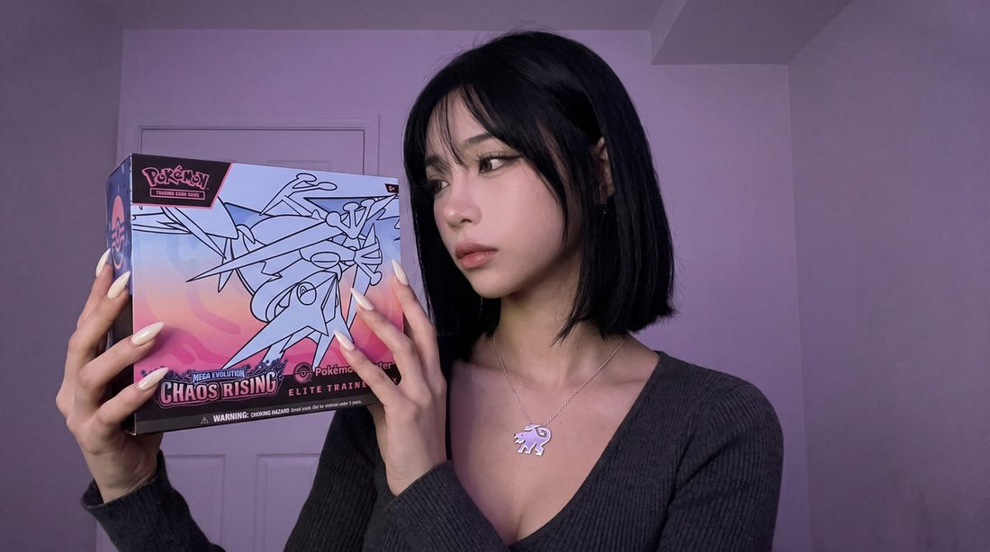 Evol Vault content host Alice holding the Chaos Rising Pokemon Center Elite Trainer Box beside her face