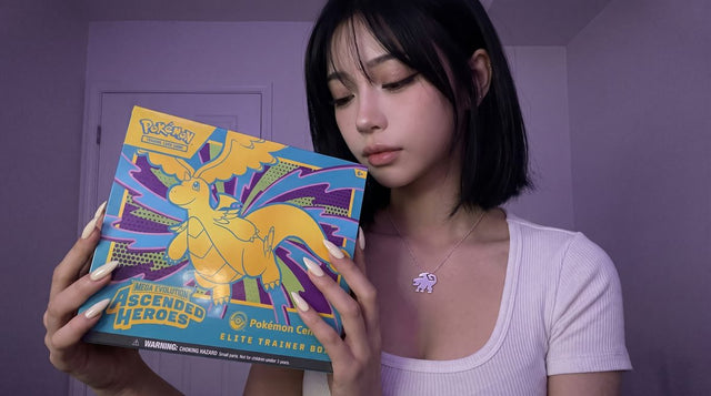 Evol Vault content host Alice holding the Ascended Heroes Pokemon Center Elite Trainer Box