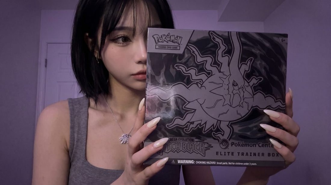 Evol Vault content host Alice holding the Pitch Black Pokemon Center Elite Trainer Box