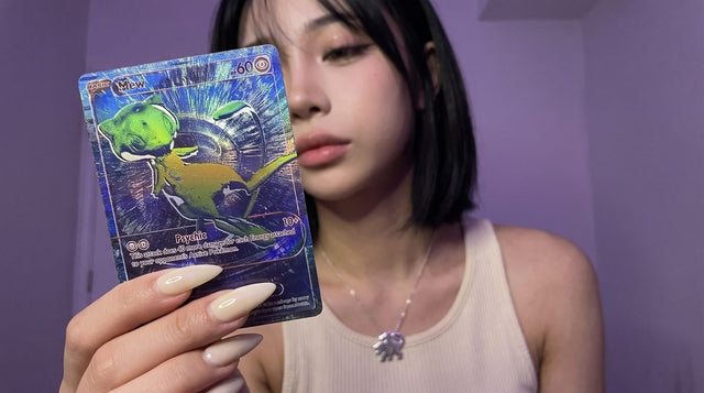 Evol Vault content host Alice holding the blue B/RGB Mew RGB Rare card from Pokemon 30th Celebration