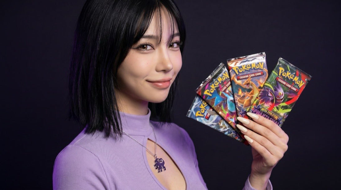 Multiple Pokemon Phantasmal Flames booster packs presented by the Evol Vault content host in editorial product photography on a dark studio backdrop